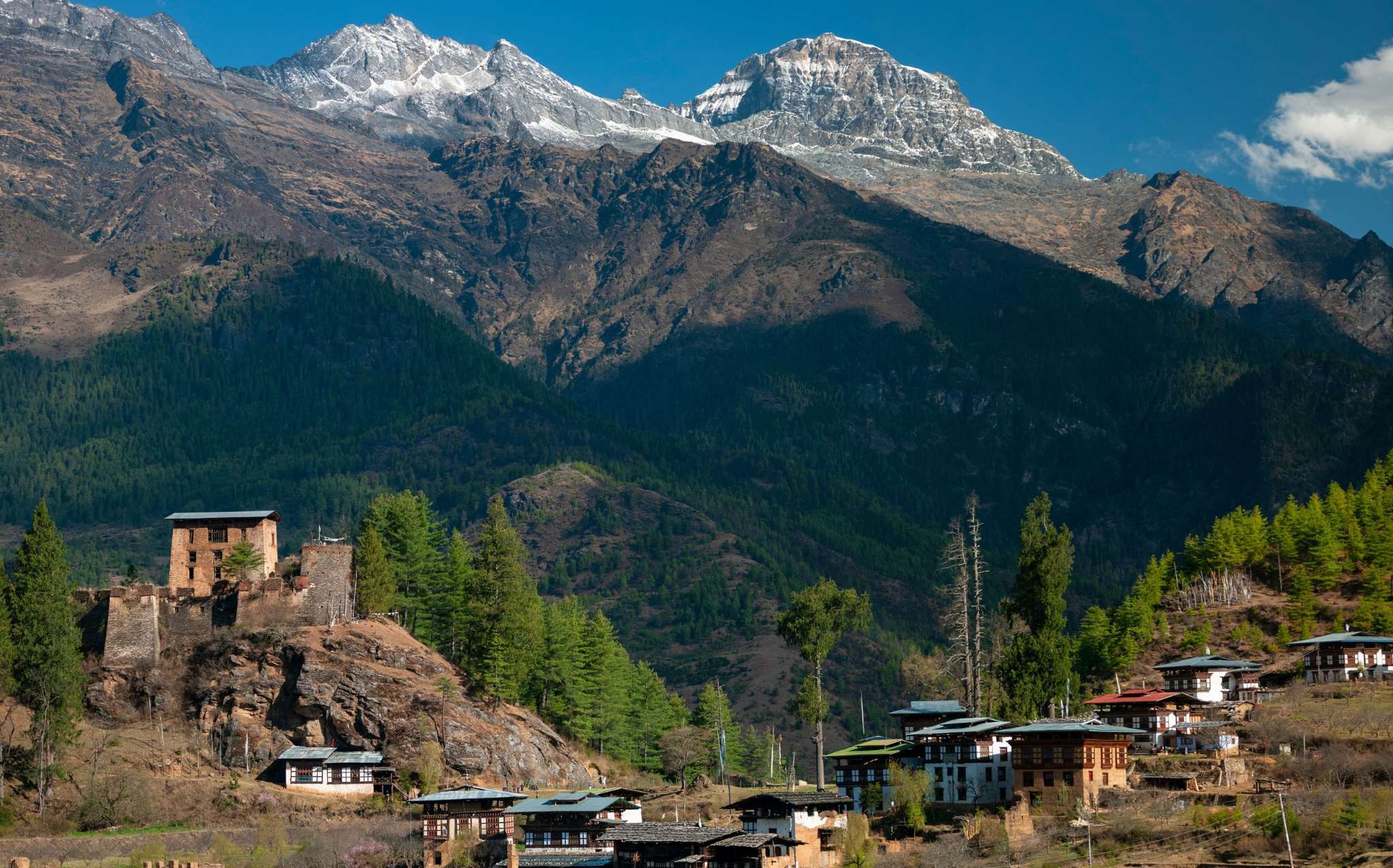 Drukgyel Dzong stands partially ruined beneath Mount Jomolhari.