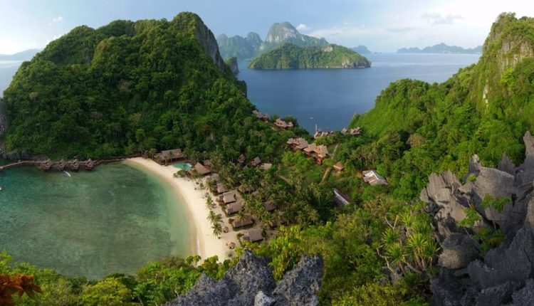 Island hopping in the Philippines overlooking a secluded tropical beach and limestone islands in Palawan
